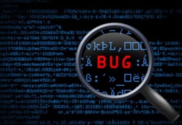 Magnifying glass focusing on the word "BUG" in red text against a background of blue code on a black screen.