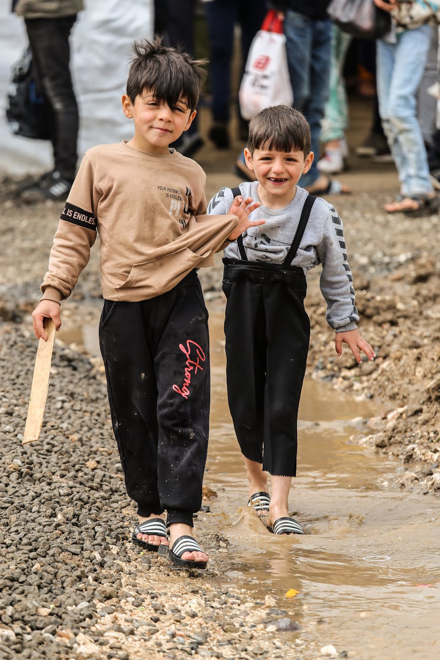 boys walking in the stream of water